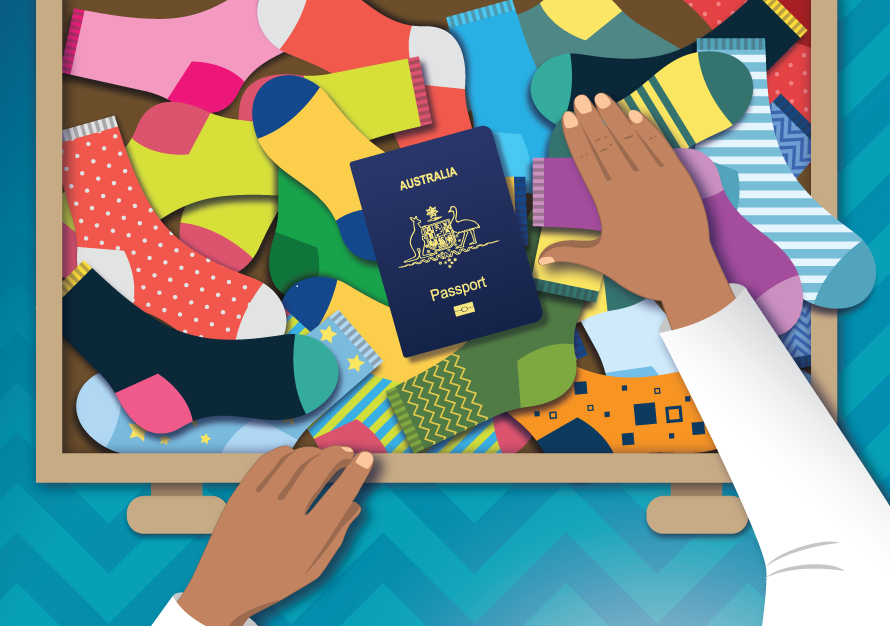 A passport is revealed among a collection of colourful socks in a drawer.