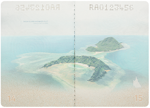 An image of Dauar Island and Waier Islet in the Torres Strait Islands on the visa pages in the R Series passport. The image stretches across both pages, a crescent-shaped green island in the foreground and a second smaller island in the background, surrounded by blue ocean.