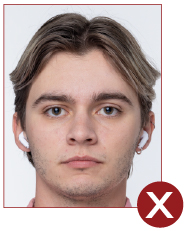 Image of unacceptable passport photo, person wearing wireless earbuds