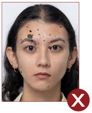Image of unacceptable passport photo, image  has ink stains across face