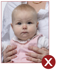 Image of unacceptable passport photo, baby with parent hands showing