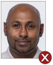 Image of unacceptable passport photo, person with a subtle expression
