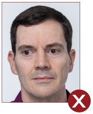 Image of unacceptable passport photo, person looking away from camera